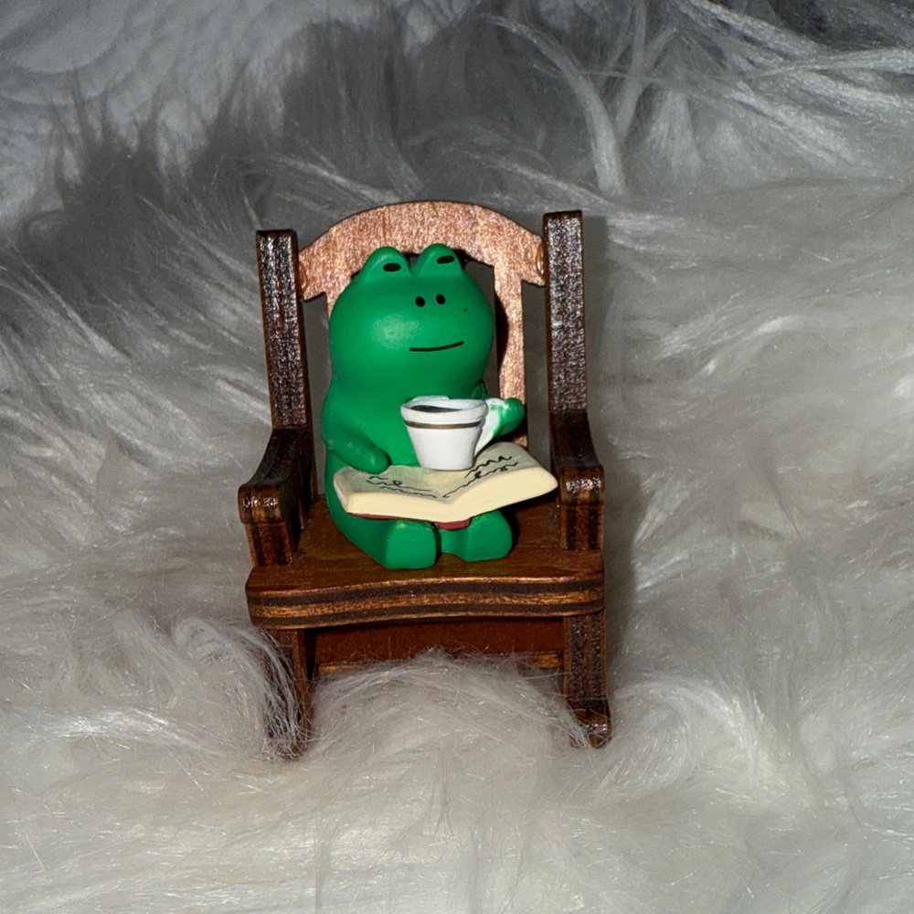 Green Frog Figurine on Wooden Chair